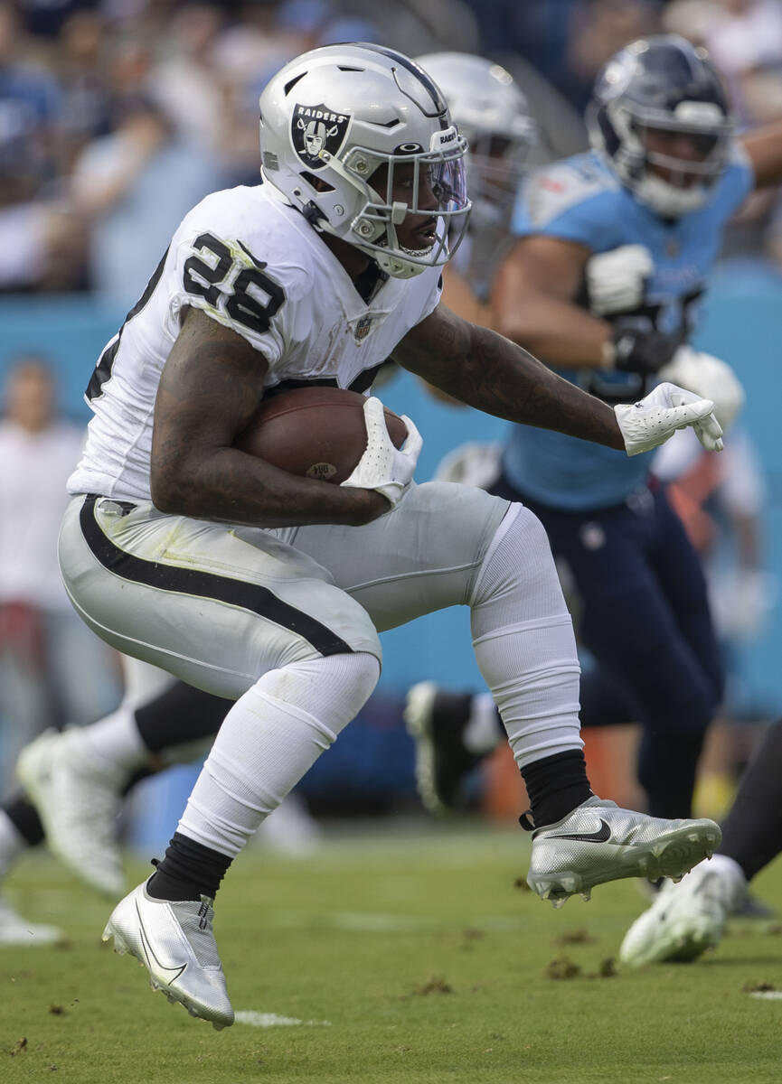 Raiders running back Josh Jacobs (28) looks for room to run during the first half of an NFL gam ...