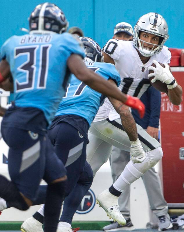 Raiders wide receiver Mack Hollins (10) makes a catch and looks to shake coverage from Tennesse ...