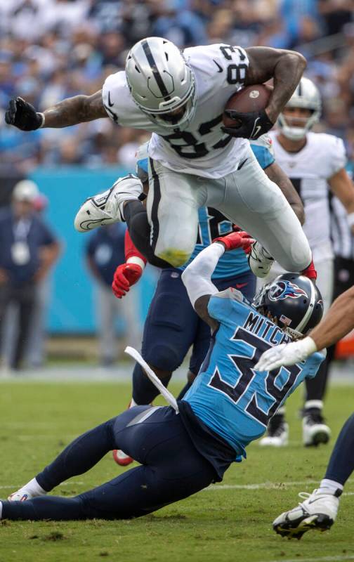 Raiders tight end Darren Waller (83) leaps over Tennessee Titans cornerback Terrance Mitchell ( ...