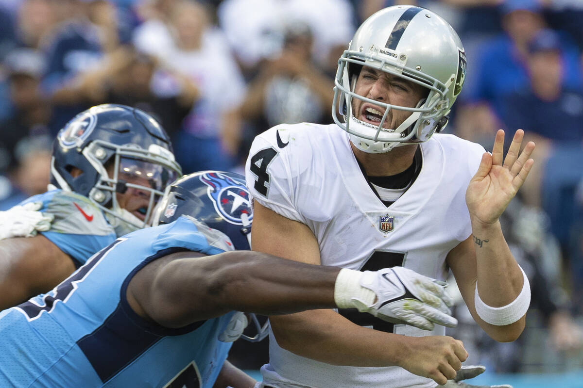 Raiders quarterback Derek Carr (4) is hit by Tennessee Titans defensive tackle Jeffery Simmons ...