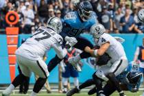 Raiders quarterback Derek Carr (4) is sacked by Tennessee Titans defensive end Denico Autry (96 ...