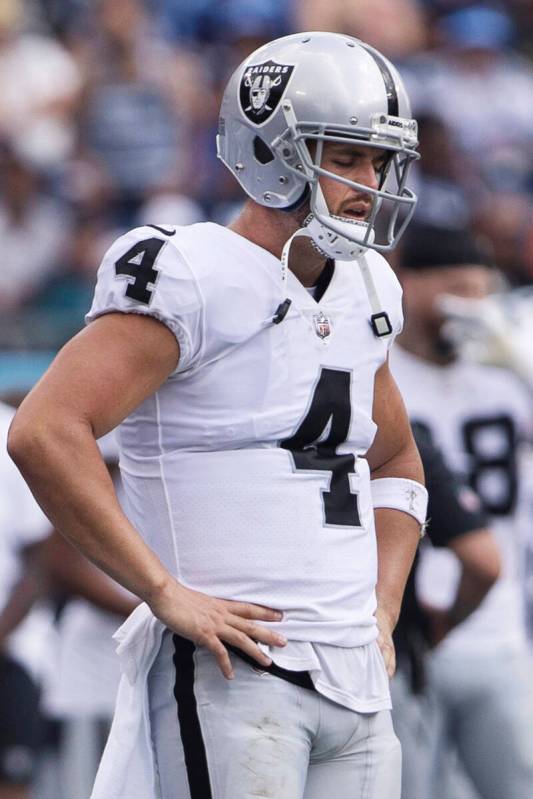 Raiders quarterback Derek Carr (4) stands on the sideline in contemplation during the second ha ...
