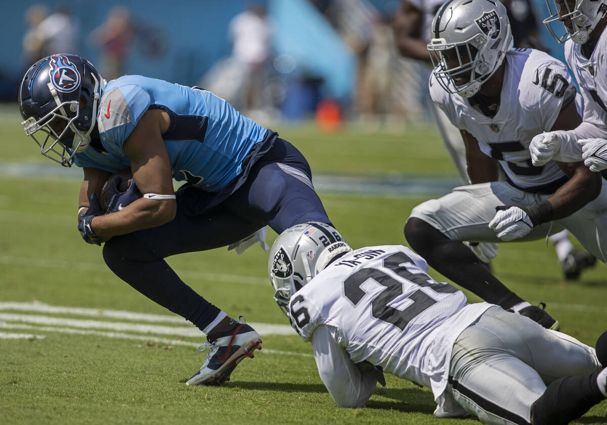 Raiders cornerback Rock Ya-Sin (26) tackles Tennessee Titans wide receiver Robert Woods (2) dur ...