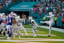 Miami Dolphins punter Thomas Morstead (4) sees the ball go backwards after attempting a punt du ...