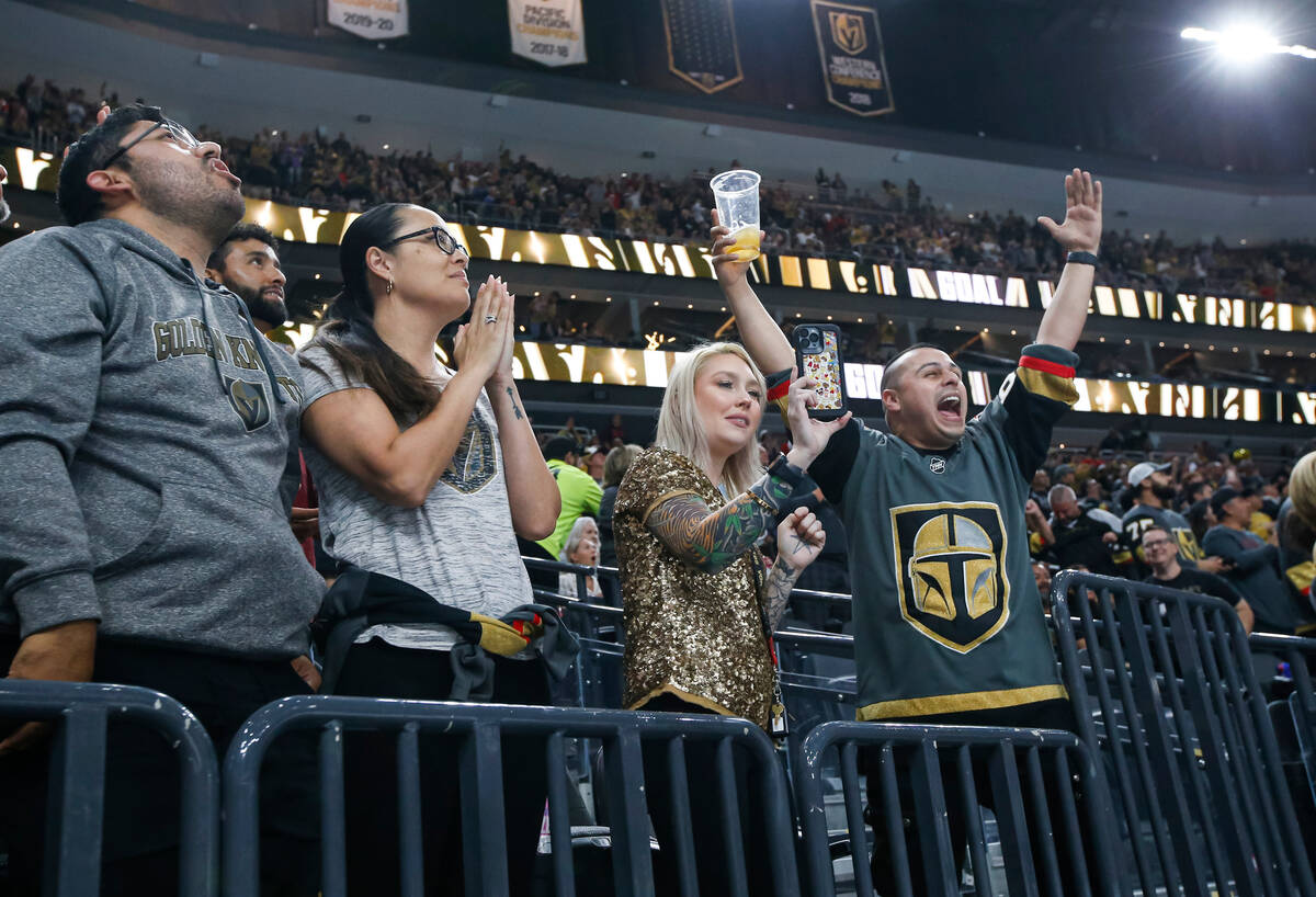 Golden Knights fans celebrate a goal against the Los Angeles Kings during the first period of a ...