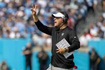 Raiders head coach Josh McDaniels holds up two fingers as he walks on the field during the seco ...