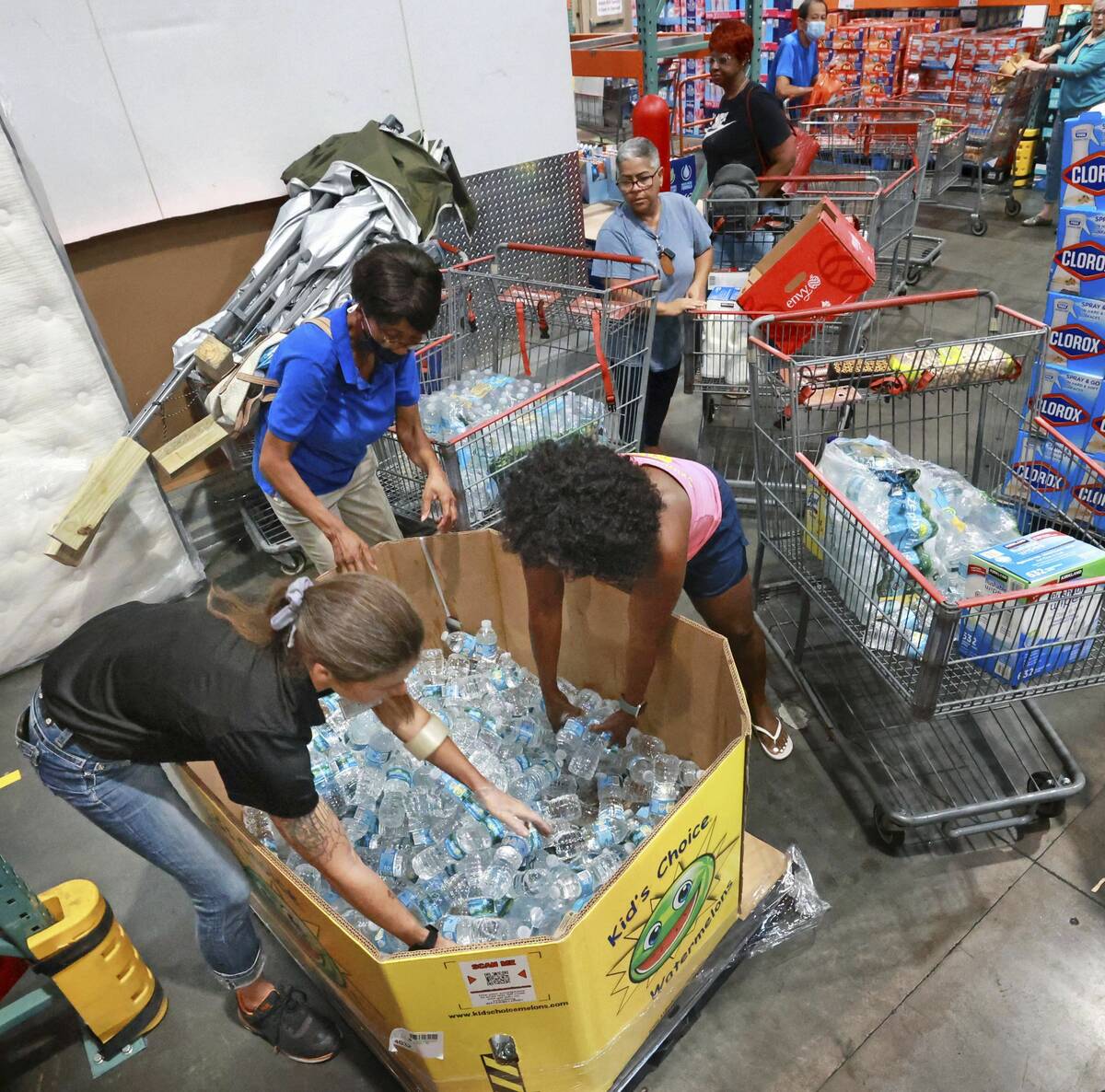 Shoppers at the Costco store in Altamonte Springs, Fla. grab bottles of water from the last pal ...