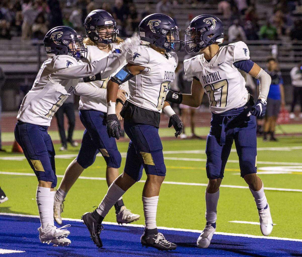 Foothill wide receiver Jayden Robertson (6) is congratulated on his go ahead score over Green V ...