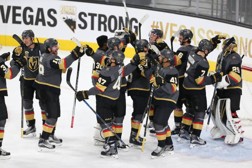 Vegas Golden Knights celebrate their 5-2 victory against Arizona Coyotes in their NHL season ho ...
