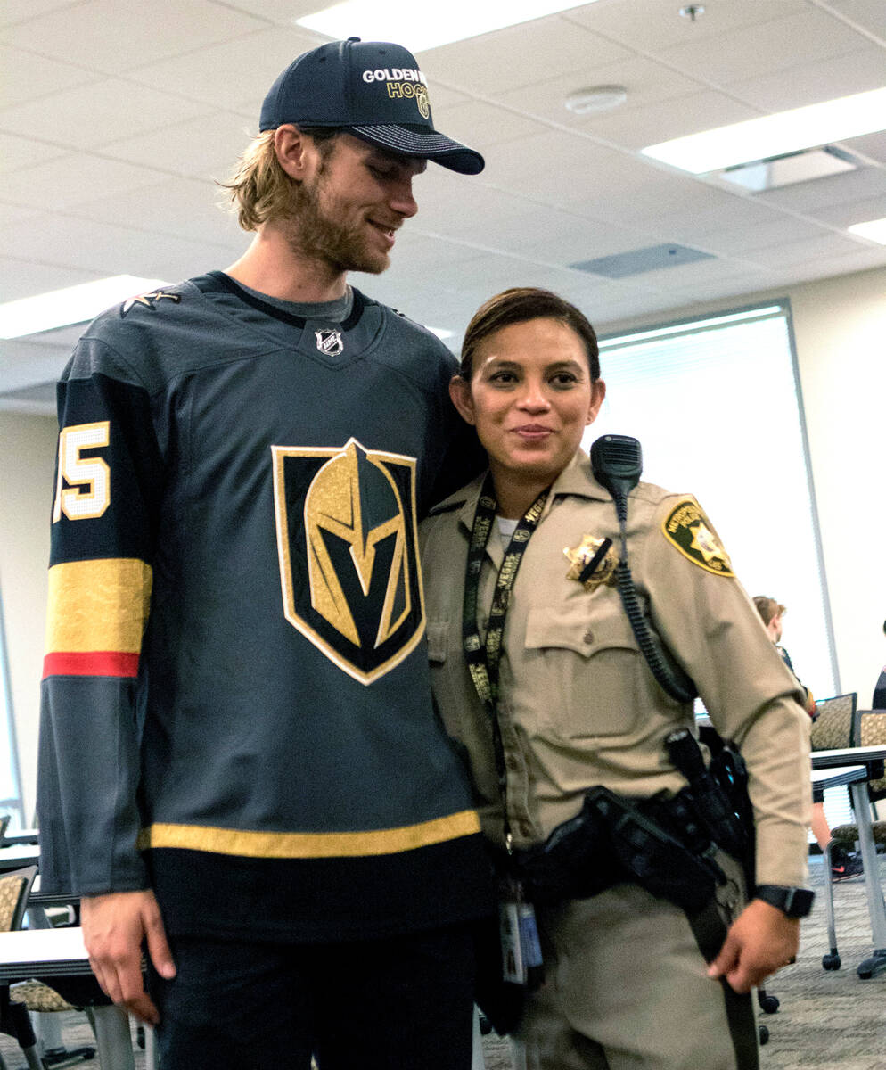 Vegas Golden Knights defenseman Jon Merrill (15) with Metro detective Maria Fulwiler during a t ...
