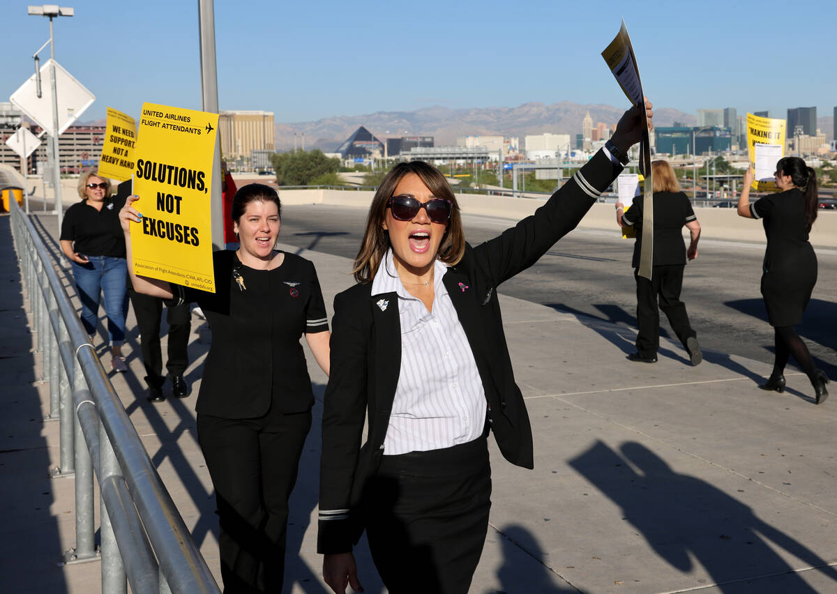 United Airlines flight attendants, including Lani Scutella, picket outside Terminal 3 at Harry ...