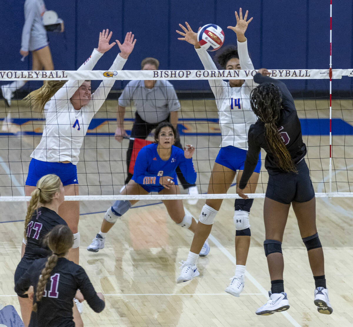 Bishop Gorman players look to block a shot by Faith Lutheran's Italya Cloyd (5) during the seco ...