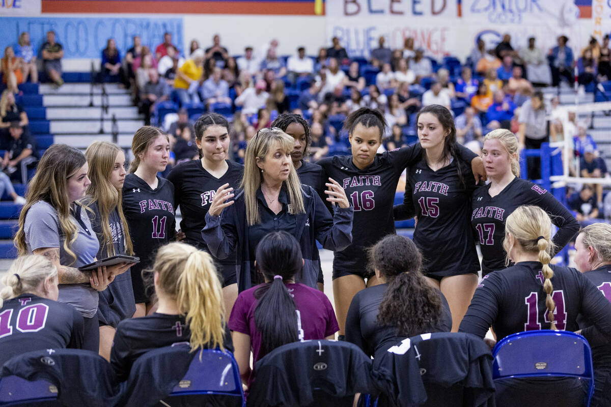 Faith Lutheran's Head Coach Amy Fisher talks with her players during a timeout versus Bishop Go ...