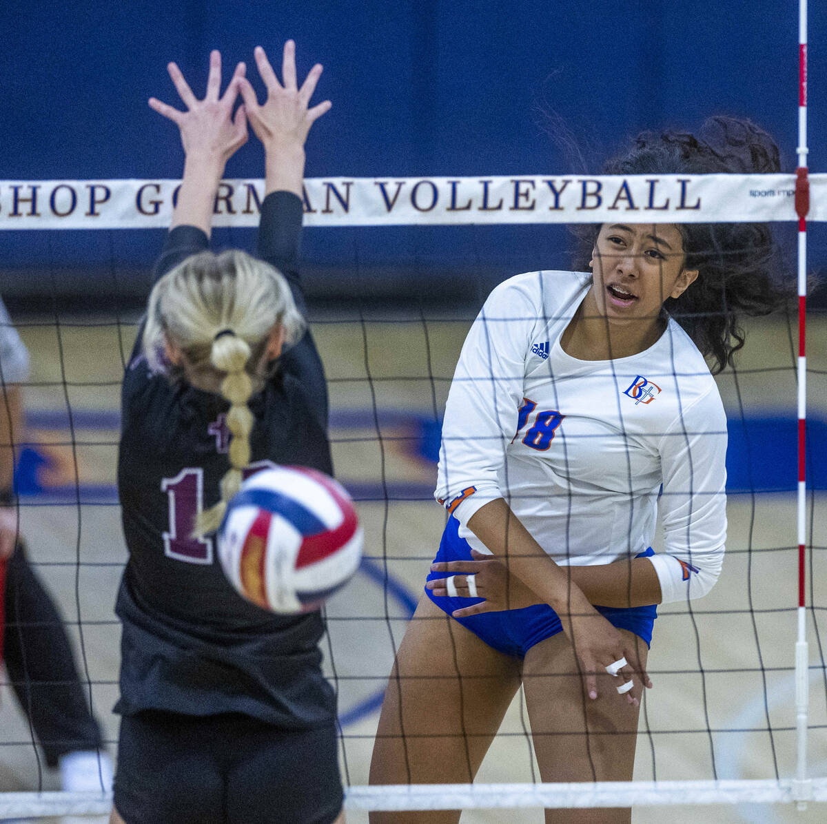 Bishop Gorman's Leilia Toailoa (18) sends a shot past Faith Lutheran's Ella Swinn (10) during t ...