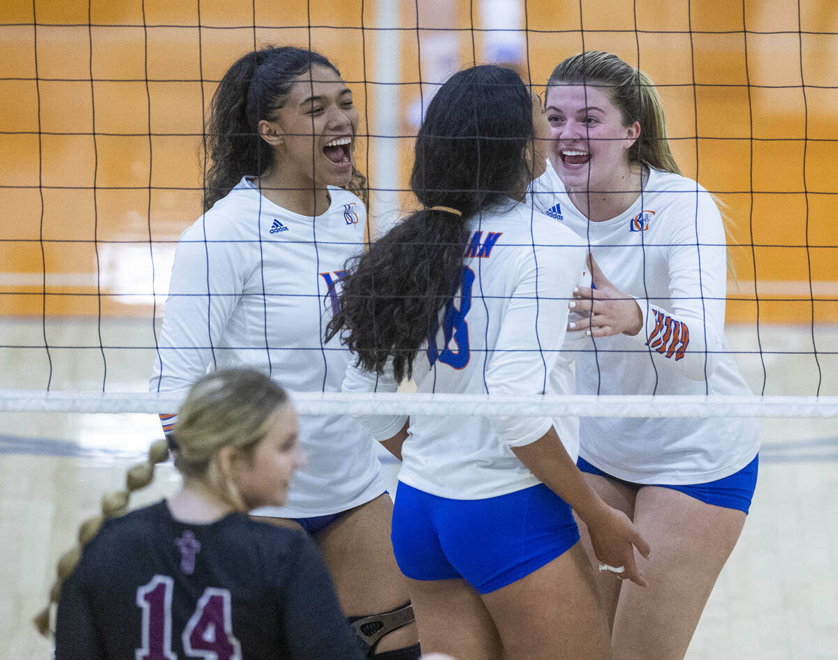 Bishop Gorman's Leilia Toailoa (18) is congratulated by teammates on a kill shot past Faith Lut ...