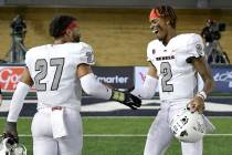 UNLV linebacker Austin Ajiake (27) celebrates with quarterback Doug Brumfield (2) after UNLV de ...