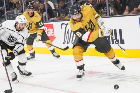 Golden Knights forward Phil Kessel (8) moves the puck under pressure from the Los Angeles Kings ...
