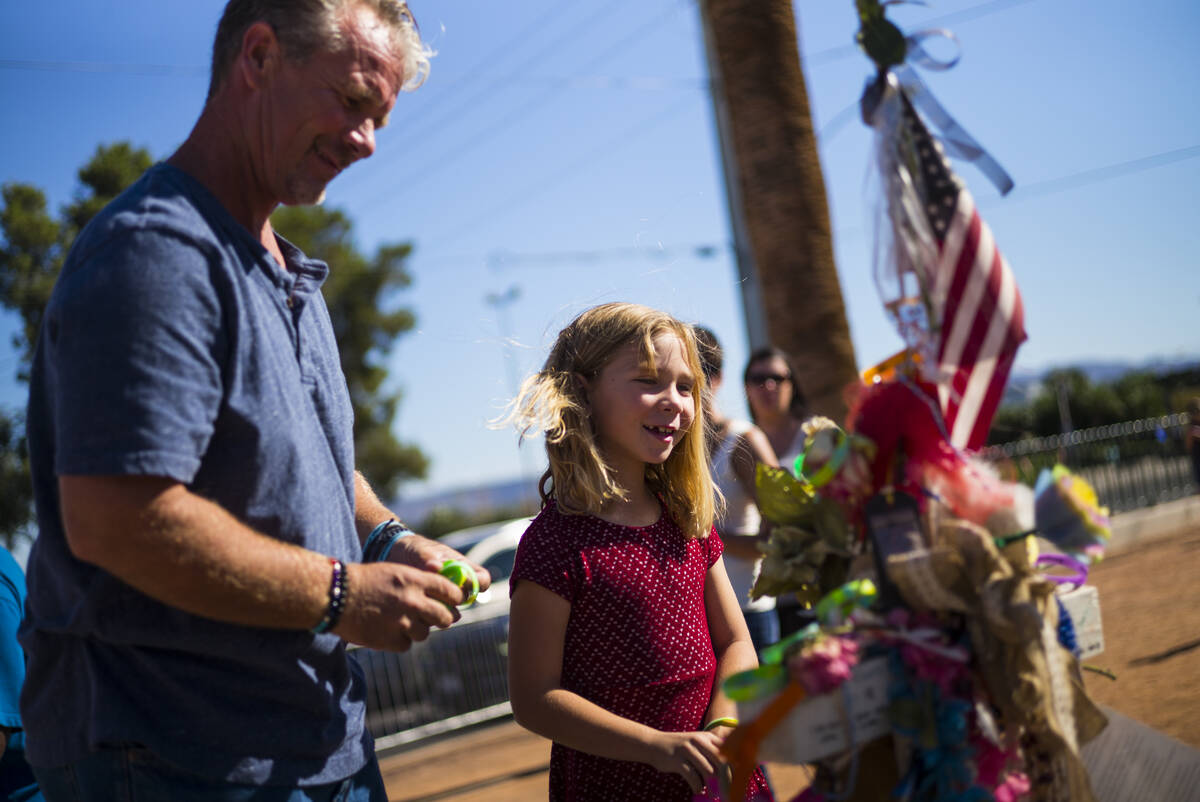 Robert Patterson, left, and daughter Brooke, then 7, visit the makeshift memorial for Lisa Patt ...