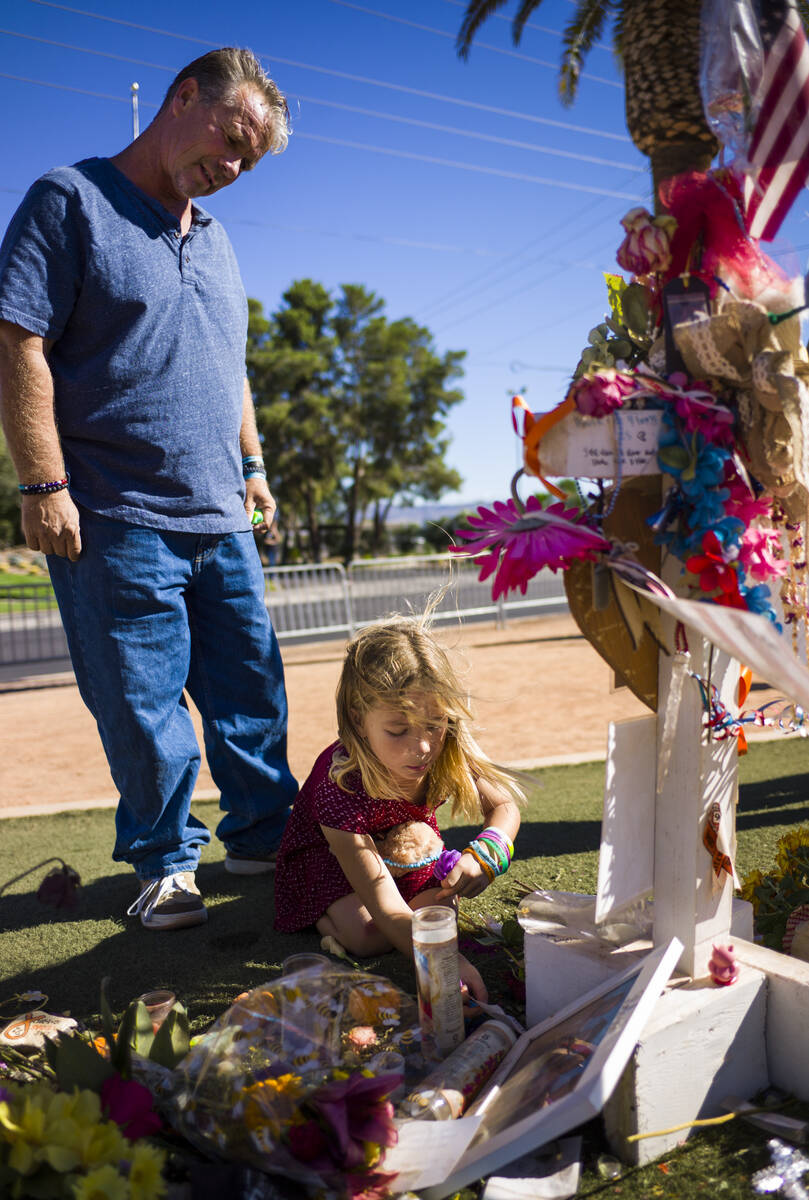 Robert Patterson, left, and daughter Brooke, then 7, visit the makeshift memorial for Lisa Patt ...