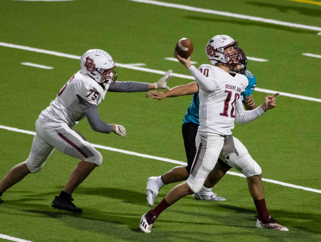 Desert Oasis quarterback Tyler Stott (10) throws under pressure against Silverado High during t ...