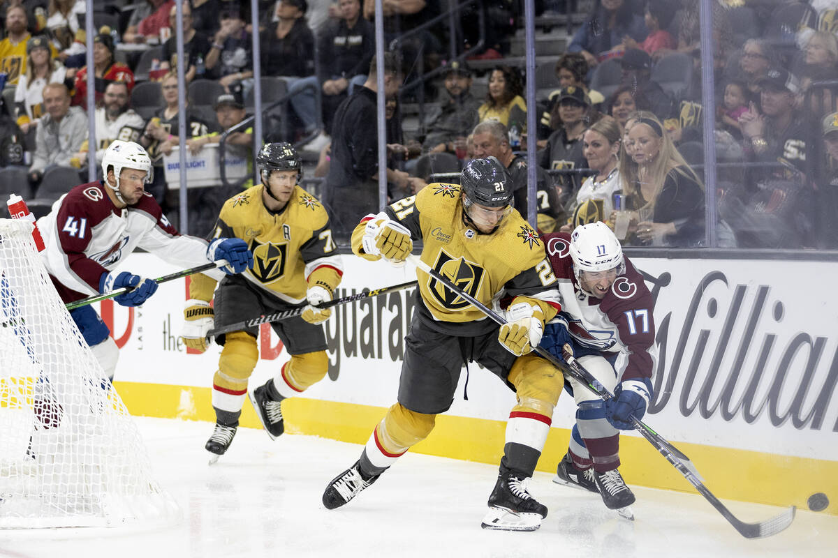 Golden Knights center Brett Howden (21) and Avalanche defenseman Brad Hunt (17) skate for the p ...