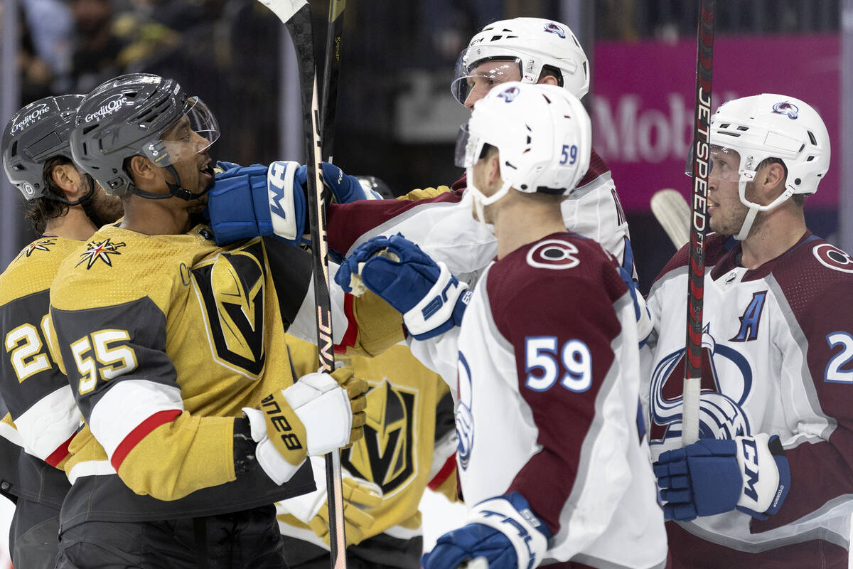 Golden Knights right wing Keegan Kolesar (55) fights with Avalanche defenseman Keaton Middleton ...