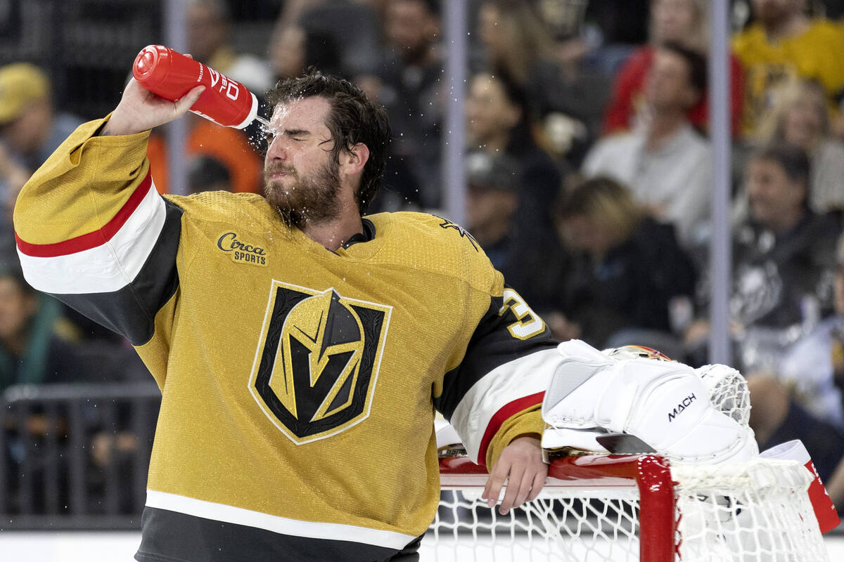 Golden Knights goaltender Logan Thompson (36) squirts his face with water during the second per ...