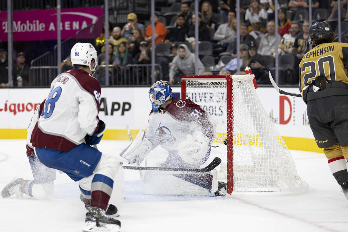 Golden Knights center Chandler Stephenson (20) scores a goal on Avalanche goaltender Jonas Joha ...