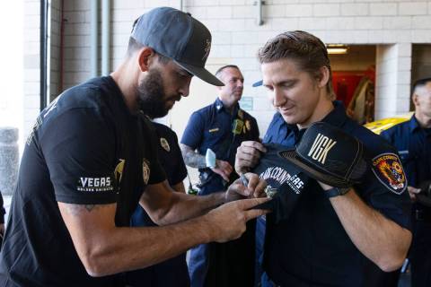 Former Vegas Golden Knights defenseman Deryk Engelland signs autograph to Clark County firefigh ...