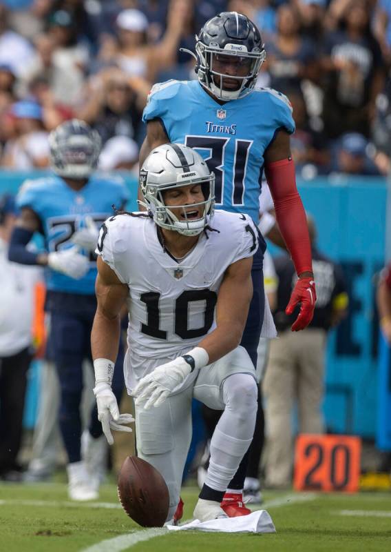 Raiders wide receiver Mack Hollins (10) celebrates a catch over Tennessee Titans safety Kevin B ...