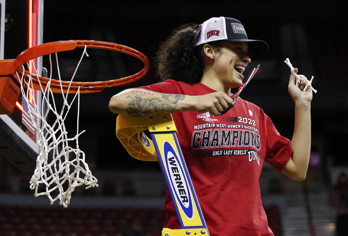 UNLV Lady Rebels guard Essence Booker reacts afterr cutting a pieces of the net after defeating ...
