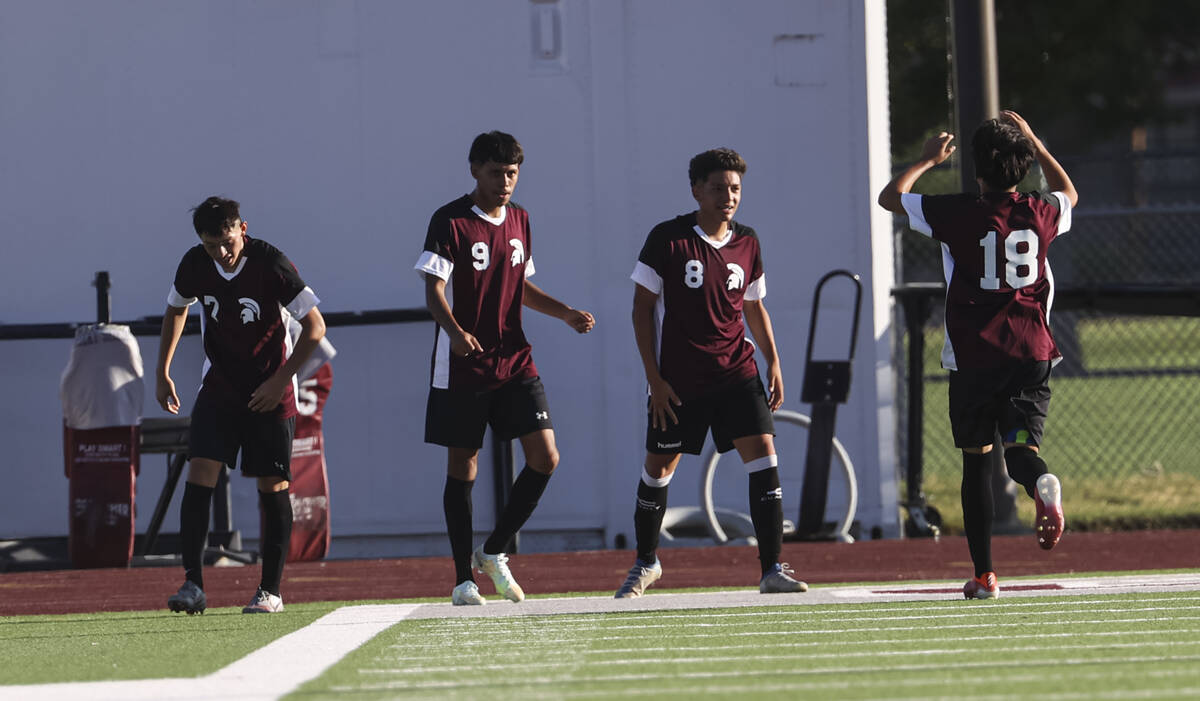 Cimarron-Memorial players react after the team scored against Las Vegas during a soccer game at ...
