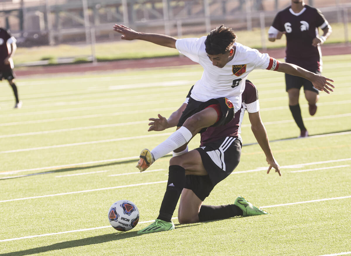 Las Vegas' Christian Valencia (9) gets tripped up by an unidentified Cimarron-Memorial player d ...