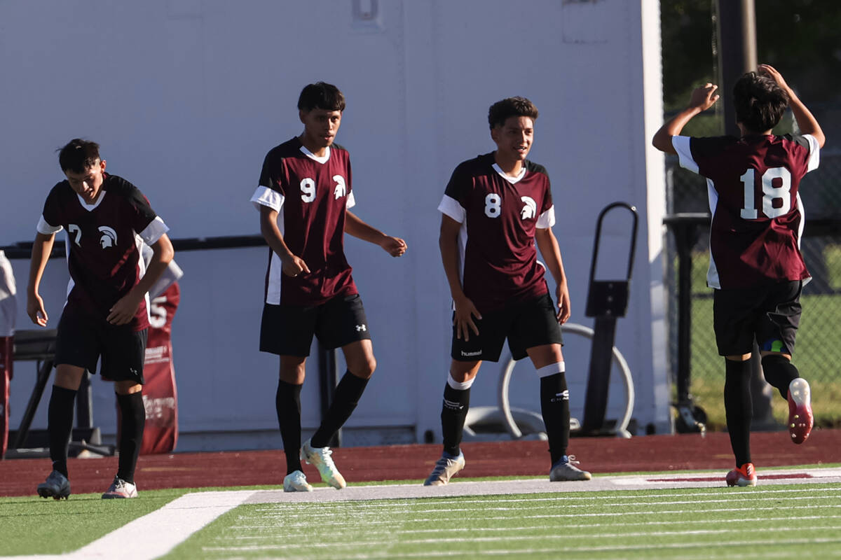 Cimarron-Memorial players react after the team scored against Las Vegas during a soccer game at ...