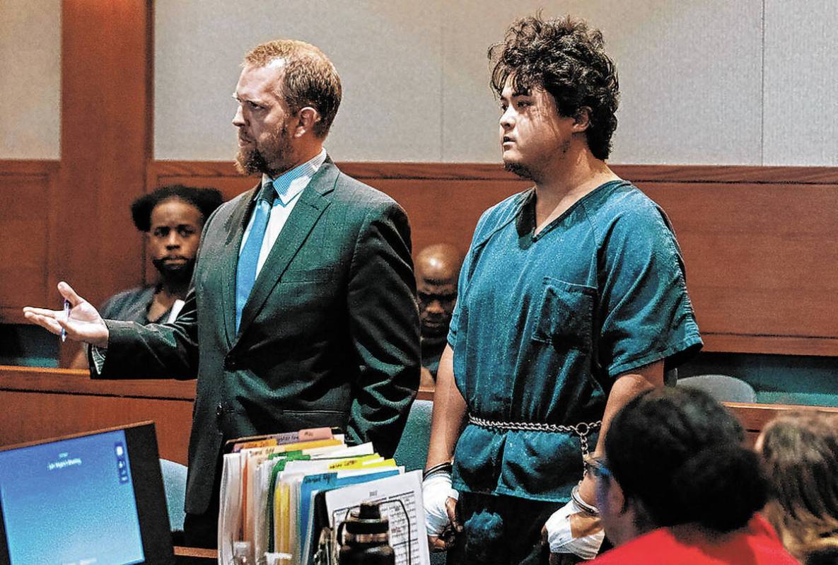 FILE - Jacob Racilis, accused of fatally stabbing his father, appears in court with his attorne ...
