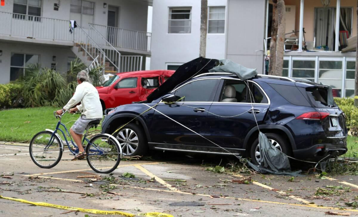 Cars damaged from a tornado spawned from an apparent overnight tornado spawned from Hurricane I ...
