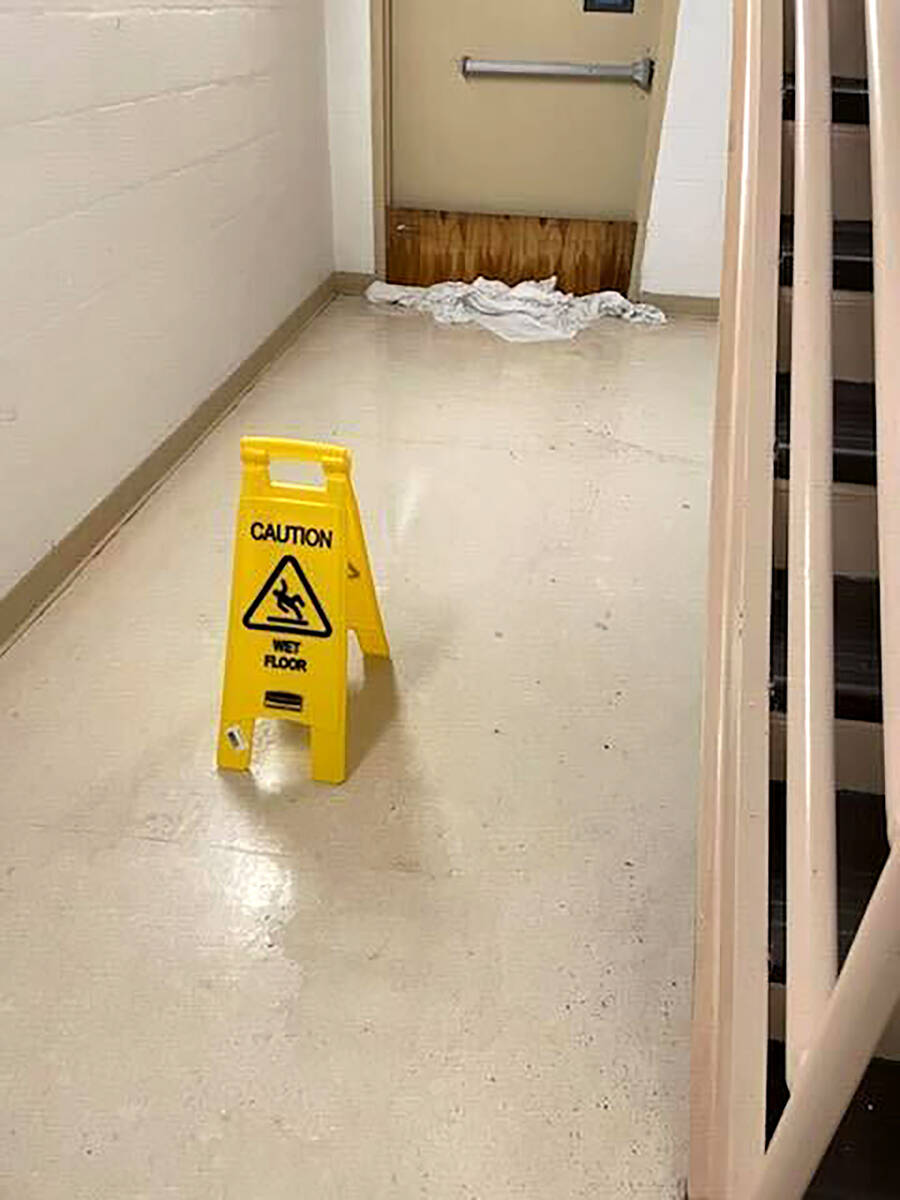In this photo provided by Dr. Birgit Bodine, a cautionary sign is displayed in a wet hallway at ...