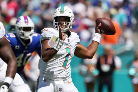 Miami Dolphins quarterback Tua Tagovailoa (1) makes a pass attempt during an NFL football game ...