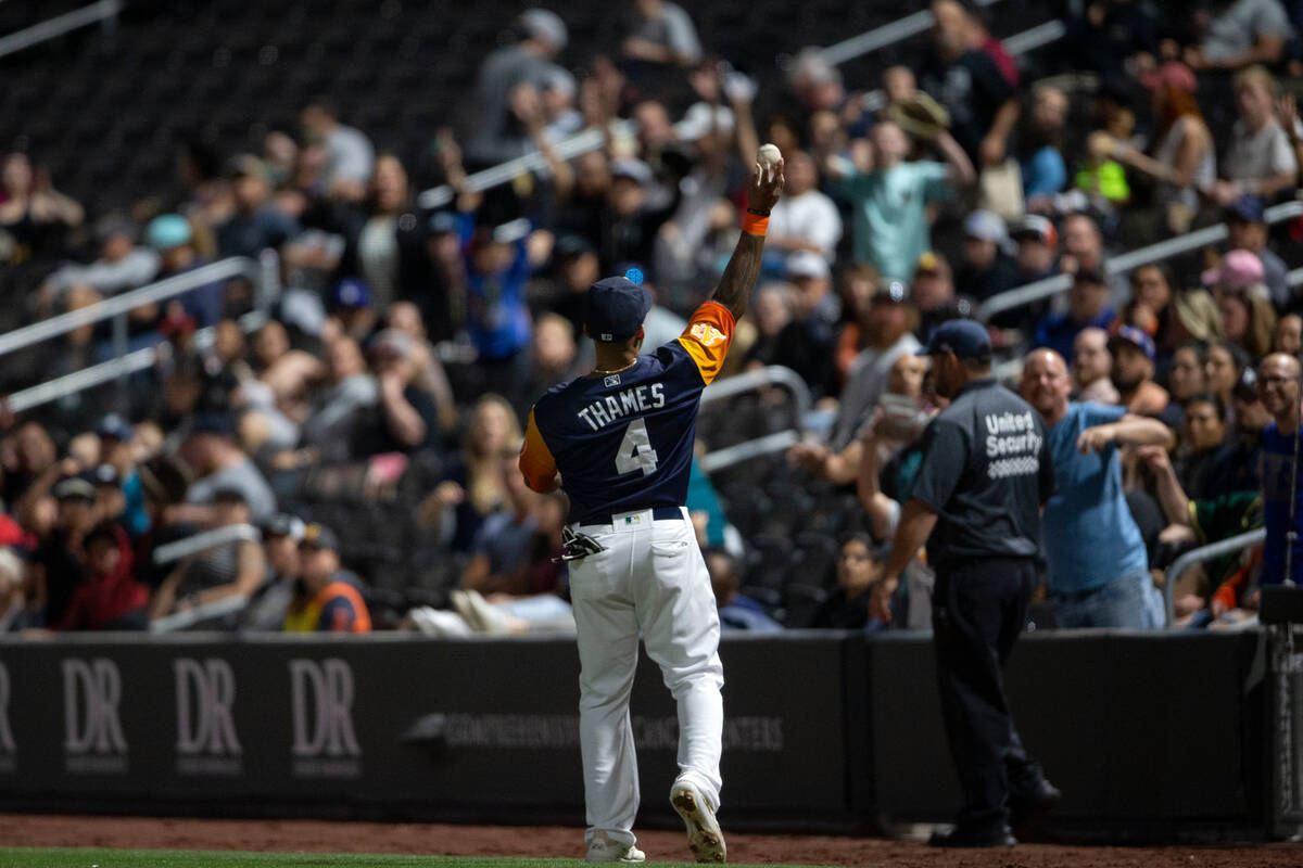 Las Vegas Aviators first baseman Eric Thames (4) throws a ball to the crowd during a Minor Leag ...