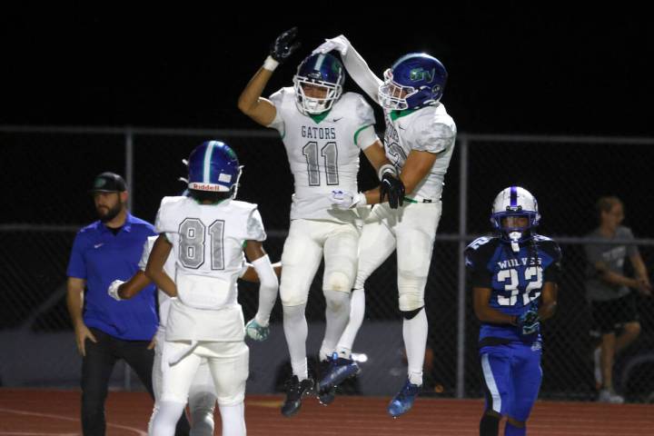 Green Valley High's wide receiver Nate Richter (11) celebrates his touchdown with his teammates ...