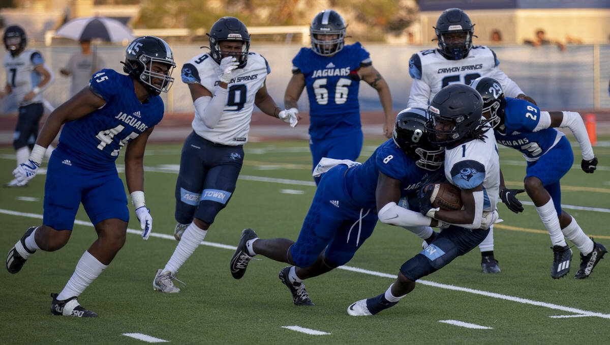 Desert Pines senior Labarrio Mays (8) tackles Canyon Springs senior Darrell Finks (1) during th ...