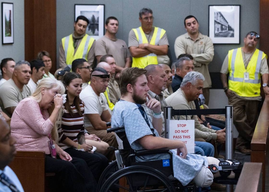 Riley McGowan, center, his mother Carmen, left, and his South West coworkers attend Danielle Ko ...