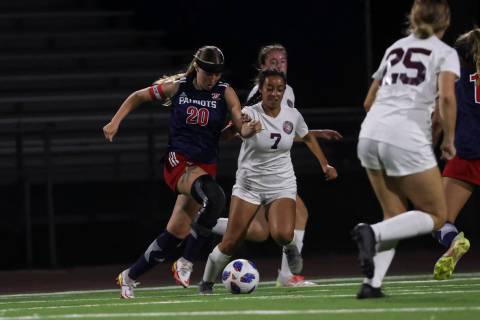 Liberty's Madisyn Marchesi (20) moves the ball under pressure from Desert Oasis' Jessica Leon ( ...