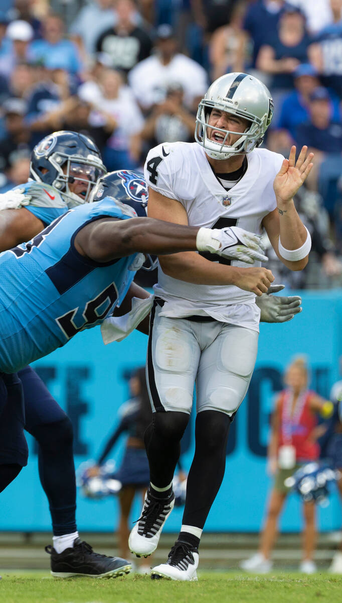 Raiders quarterback Derek Carr (4) is hit by Tennessee Titans defensive tackle Jeffery Simmons ...