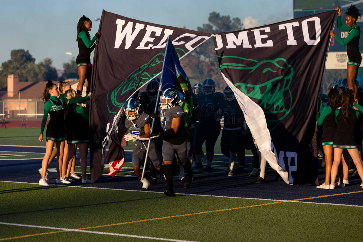 Green Valley players take the field for a football game against Desert Pines at Green Valley Hi ...