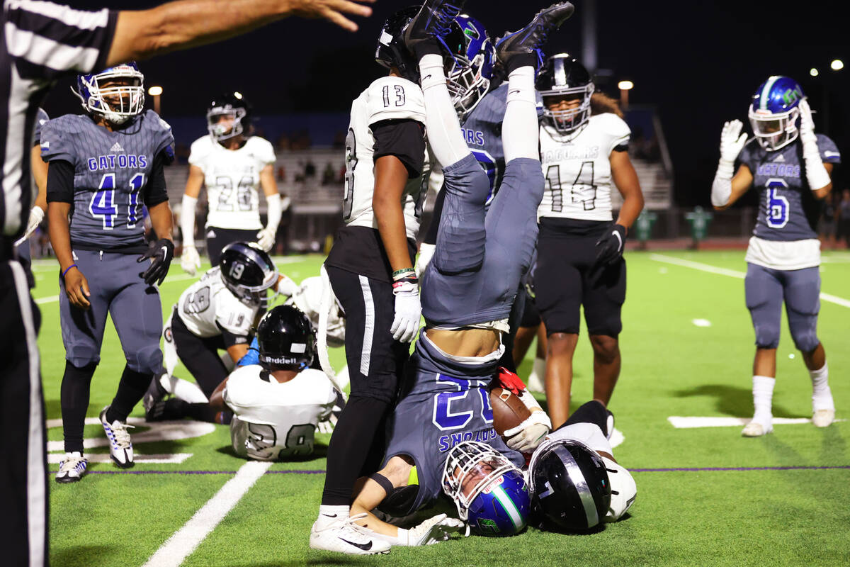 Green Valley's Daniel Brady (22) gets up after getting tackled by Desert Pines' Tyrik Simé ...