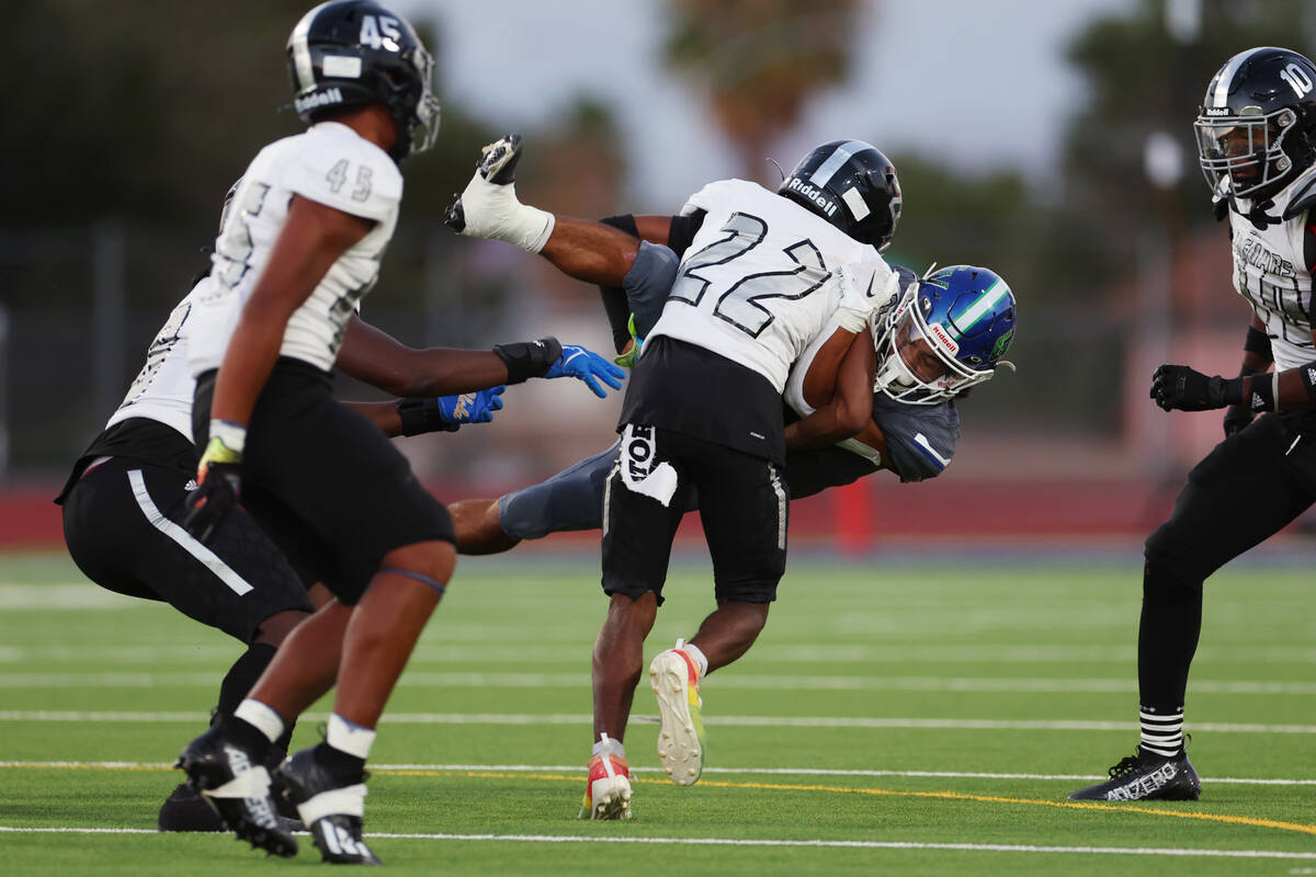 Desert Pines' Trey Jackson (22) tackles Green Valley's Freddy Rodriguez (5) in the first half o ...
