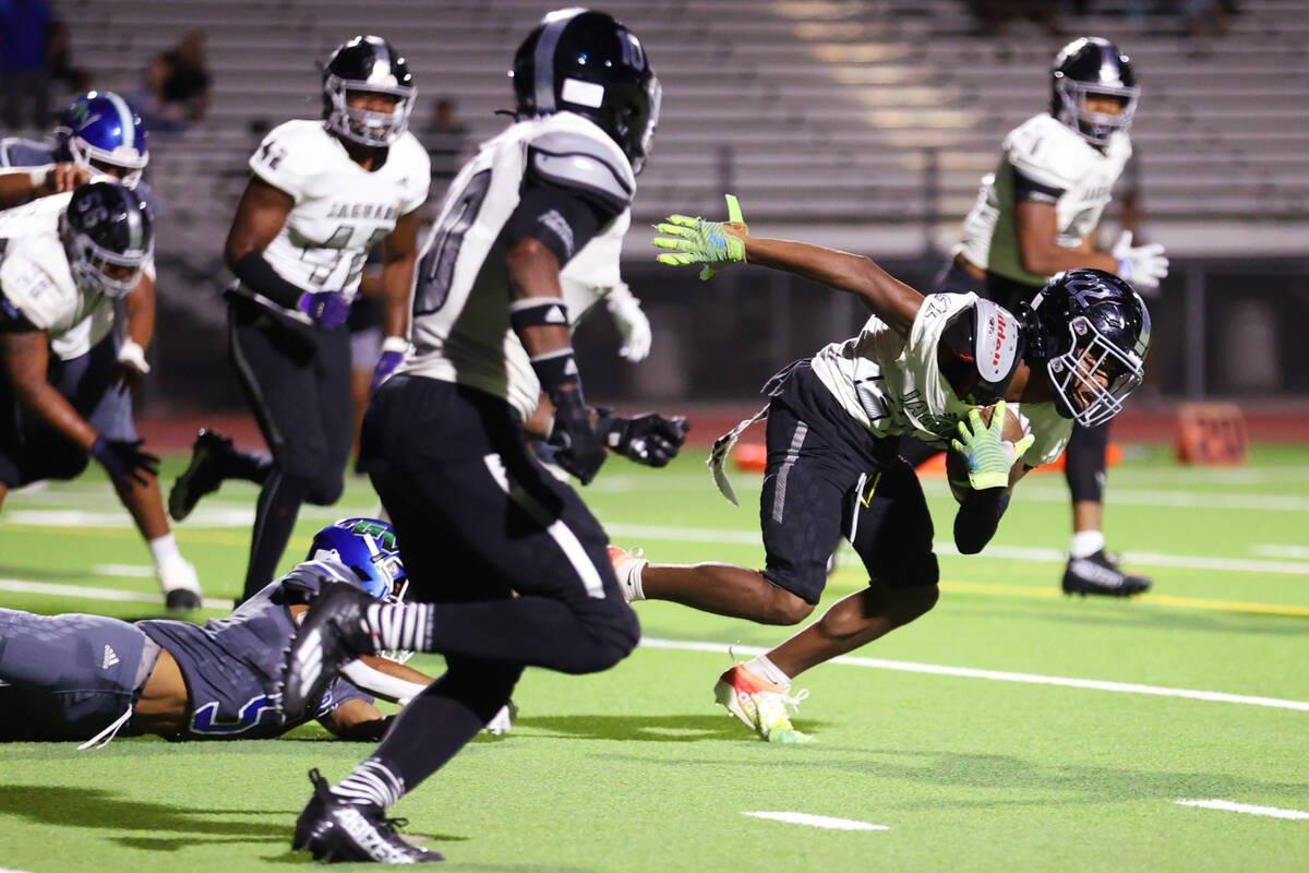 Desert Pines' Trey Jackson (22) intercepts the ball before returning it for a touchdown against ...