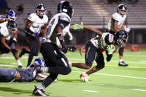 Desert Pines' Trey Jackson (22) intercepts the ball before returning it for a touchdown against ...