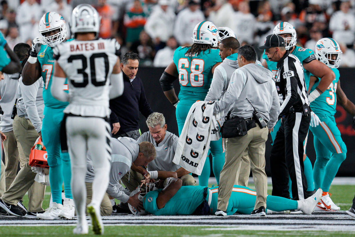 Miami Dolphins quarterback Tua Tagovailoa is attended to by medical staff after being sacked by ...